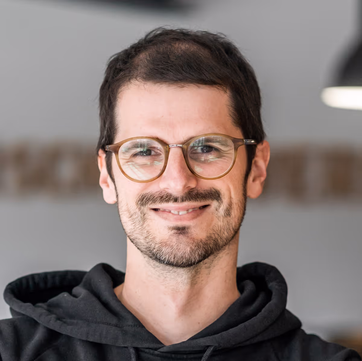 Tobi, Geschäftsführer von Schaltwerk Digital, lächelt in die Kamera.